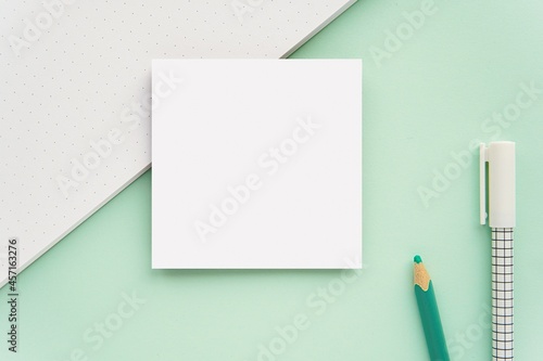 Sticky notes, memo pad, small notepad mockup on mint green background.