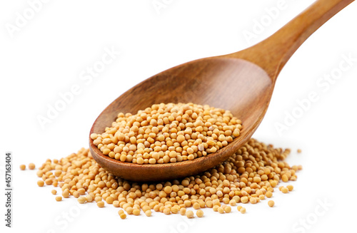 Mustard seeds in a spoon on a white background. Isolated