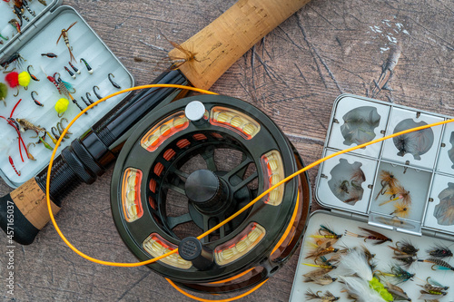 Close up selective focus of CNC Machined fishing reel and line on a shop counter flat lay top view photo