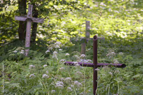 Zaniedbany opuszczony stary cmentarz katolicki z widocznymi krzyżami  photo