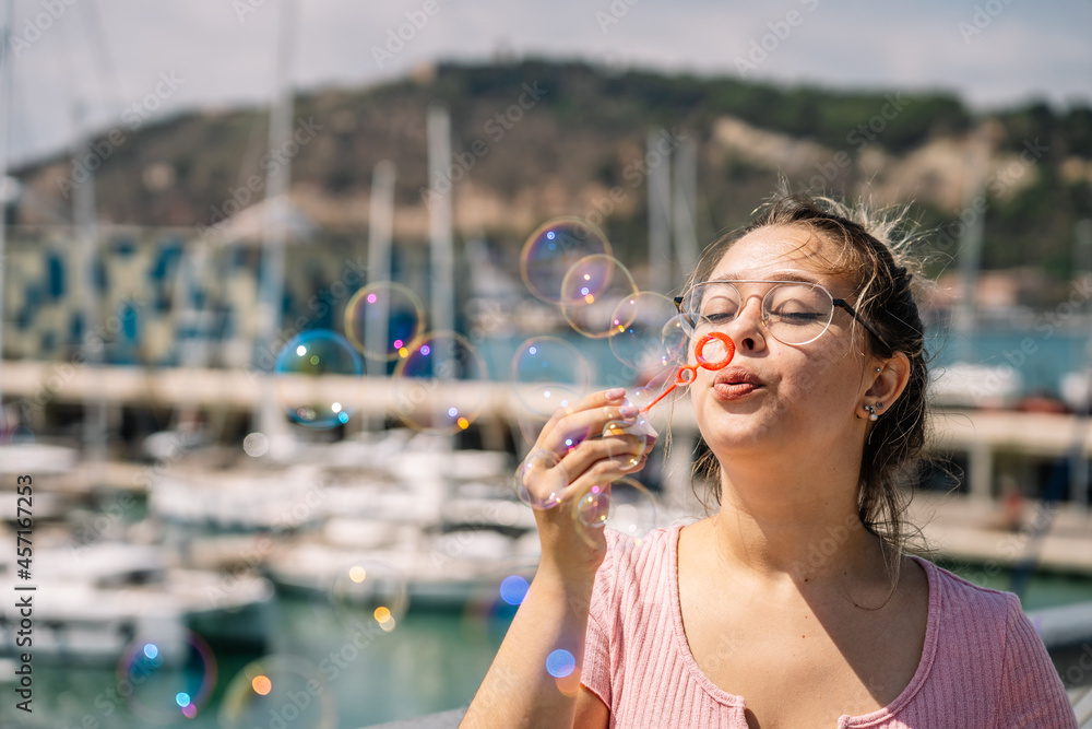 young woman blows soap bubbles young woman blows soap bubbles