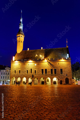 Tallinn Town Hall Square illuminated at night after raining.
