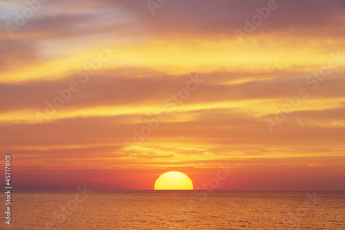 Big sun and sea sunset background. © GIS