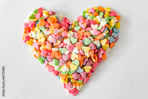 A heart-shaped collection of vibrant candy sprinkles, radiating love and sweetness, perfect for a romantic or celebratory occasion.