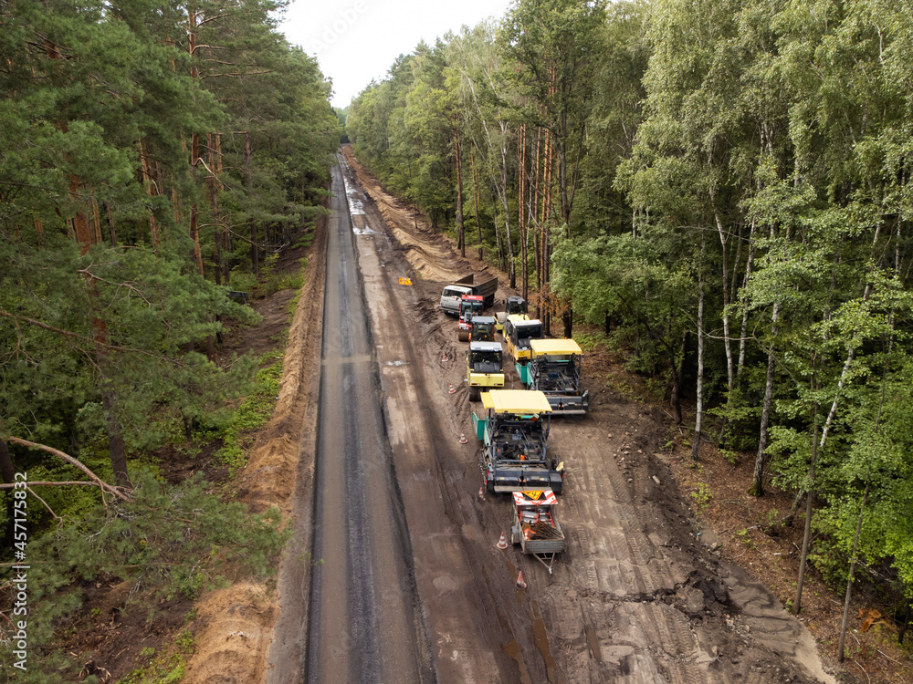 Aerial photo of road construction work in the countryside. Modern vehicles for making high-quality modern asphalt pavement Aerial photo of road construction work in the countryside. Modern vehicles for making high-quality modern asphalt pavement