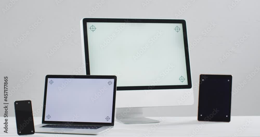 Video of laptop, smartphone, tablet and computer on white table with copy space in office Video of laptop, smartphone, tablet and computer on white table with copy space in office