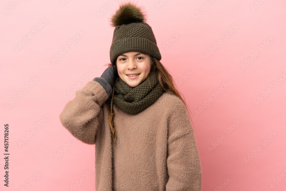 Little girl with winter hat isolated on pink background laughing Little girl with winter hat isolated on pink background laughing