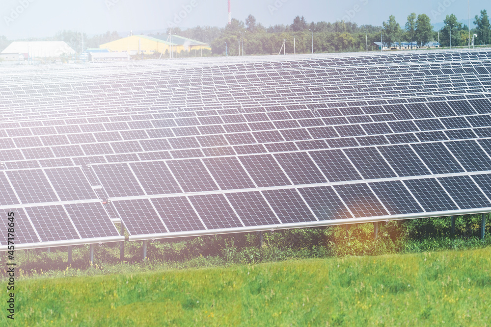 solar-powered power plant, solar module panels on the sky background. Solar energy. Environmental theme. The concept of green energy, selective focusing, glare from the sun, tinting solar-powered power plant, solar module panels on the sky background. Solar energy. Environmental theme. The concept of green energy, selective focusing, glare from the sun, tinting