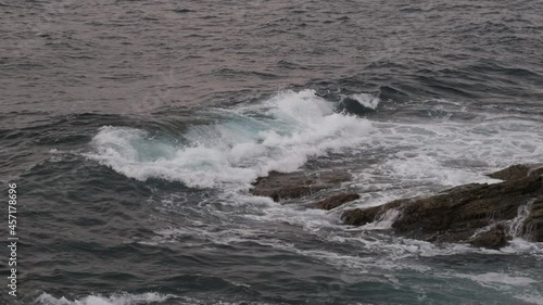 Slow motion of the sea waves crashing against the rocks of the coastline