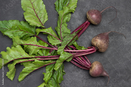 Beets with tops on table.