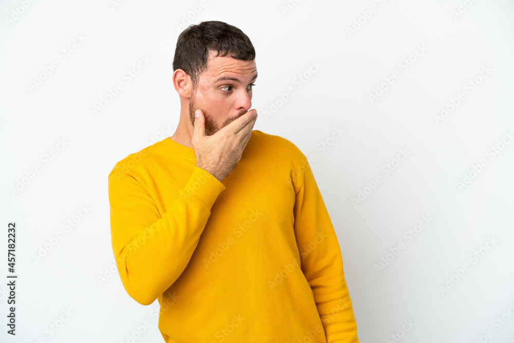 Young Brazilian man isolated on white background doing surprise gesture while looking to the side Young Brazilian man isolated on white background doing surprise gesture while looking to the side