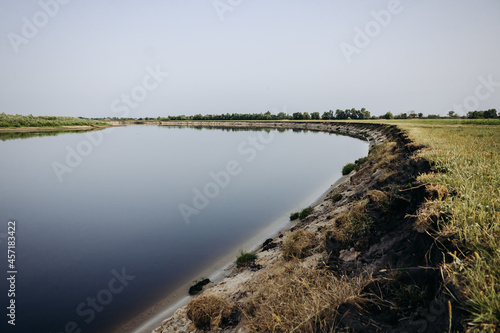 Beautiful summer landscape by the river. Picturesque steep bank of the Pripyat river, Belarus