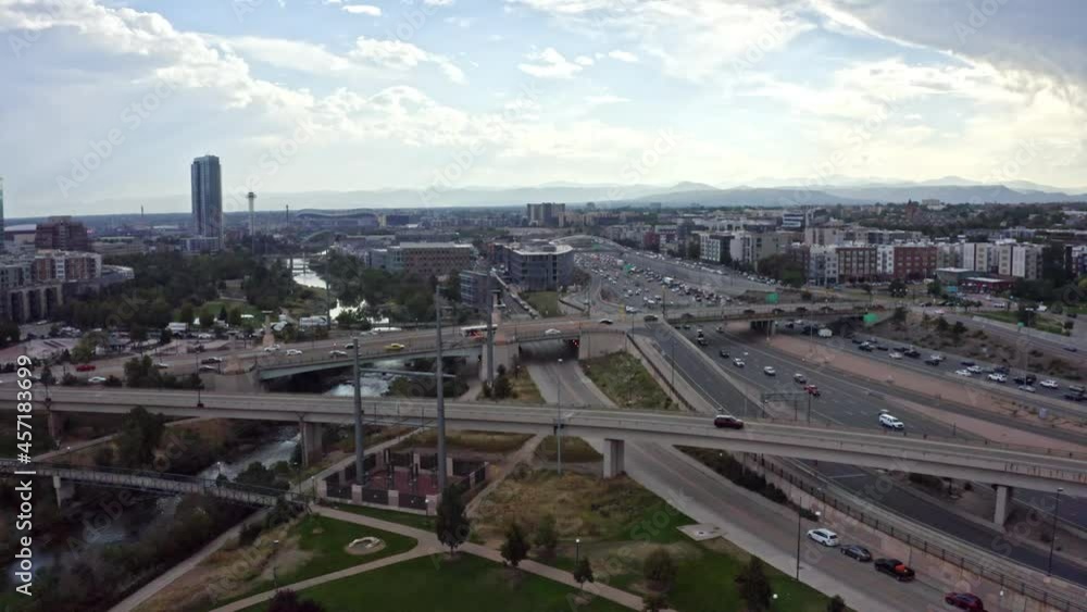 Aerial shot of evening traffic on I-25 and Speer Boulevard, panning to lower downtown Denver with views of skyline and Cherry Creek, captured by a drone in 4K resolution. Aerial shot of evening traffic on I-25 and Speer Boulevard, panning to lower downtown Denver with views of skyline and Cherry Creek, captured by a drone in 4K resolution.
