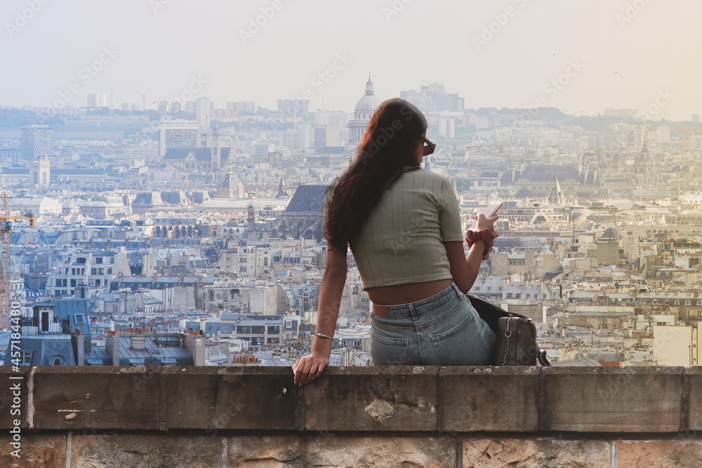 Obraz na płótnie Piękna młoda kobieta przegląda smarfona w Paryżu w salonie