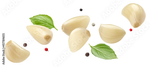 Falling peeled garlic cloves isolated on white background photo