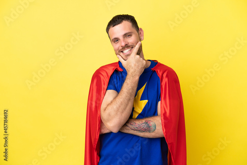 Super Hero Brazilian man isolated on yellow background smiling