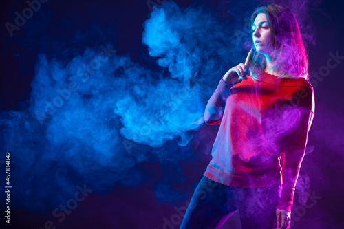 A woman with a vape device ...