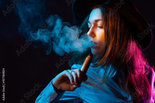 Girl is engaged in vaping. ...