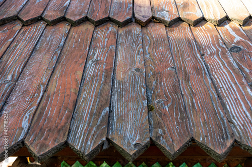 Wooden roof with peeling paint. Ancient roofing technology