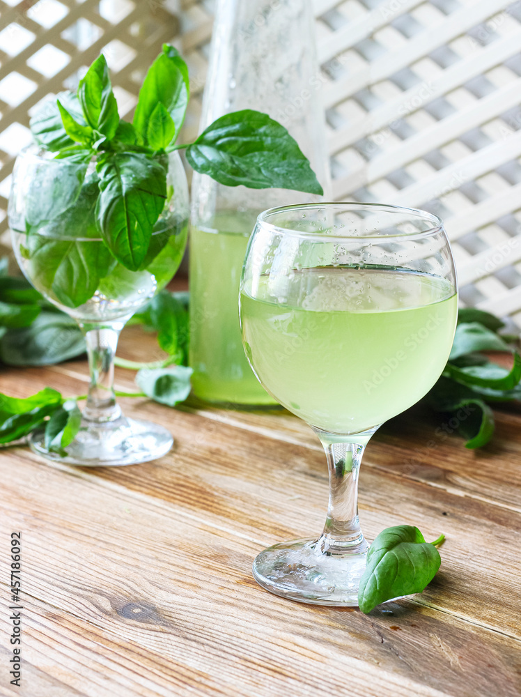 Glass of lemonade made from green basil and lemon Glass of lemonade made from green basil and lemon