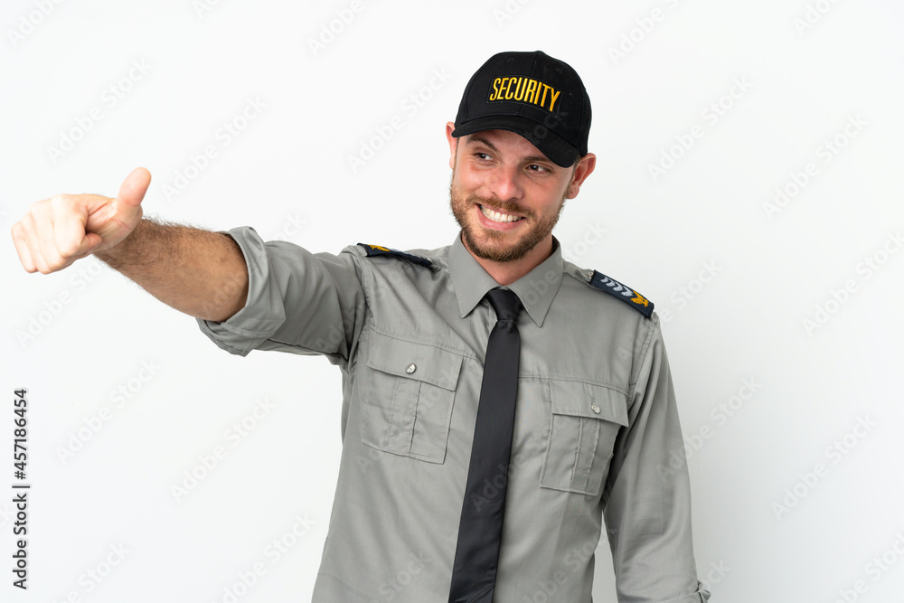 Young security Brazilian man isolated on white background giving a thumbs up gesture