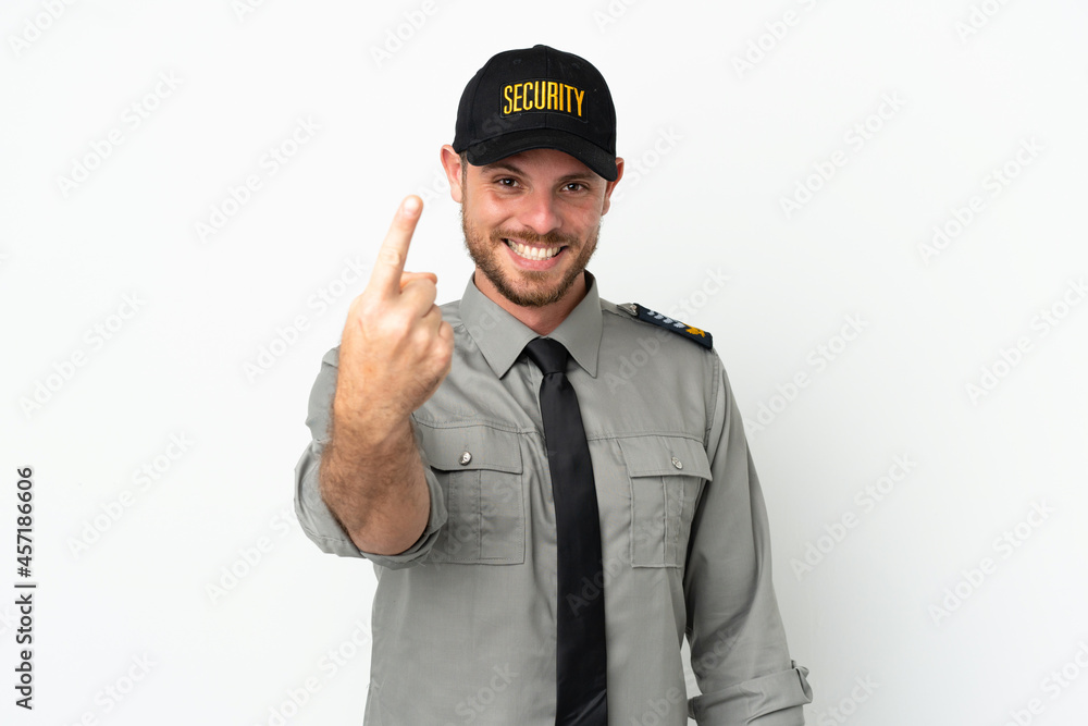 Young security Brazilian man isolated on white background doing coming gesture Young security Brazilian man isolated on white background doing coming gesture