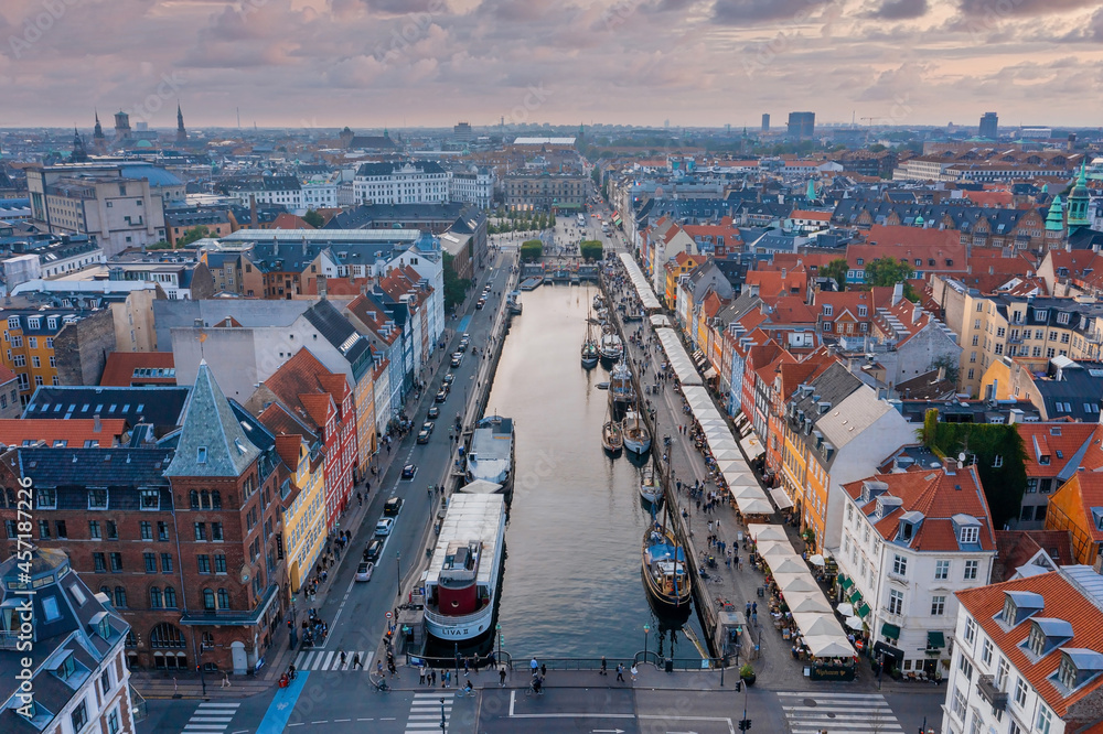 Fototapeta premium Aerial view of famous Nyhavn pier with colorful buildings and boats in Copenhagen, Denmark. The most popular place in Copenhagen.