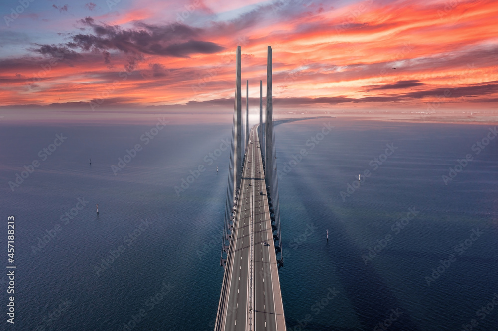 Panoramic aerial view of the Oresundsbron bridge between Denmark and Sweden, at sunset. Oresund Bridge close up view from above - obrazy, fototapety, plakaty 