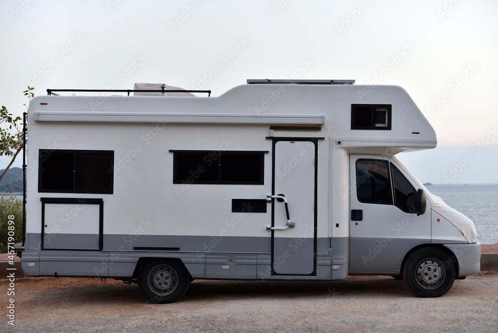 motorhome is stop on sea coast in dusk motorhome is stop on sea coast in dusk