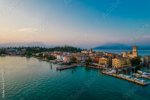 Aerial panoramic view of Sirmione city old town on lake Garda in Lombardy, Italy. Evening photo with a castle in a center © Audrius