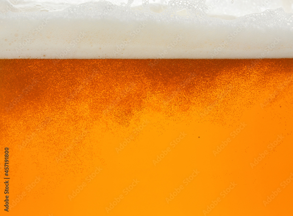 Close up background of beer with bubbles in glass Close up background of beer with bubbles in glass
