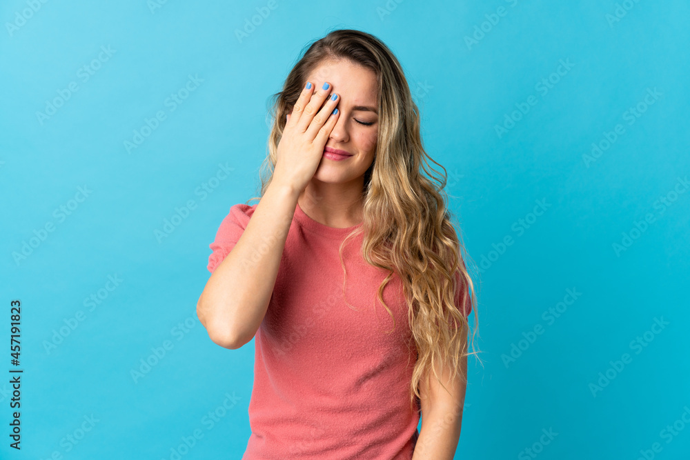Young Brazilian woman isolated on blue background with headache Young Brazilian woman isolated on blue background with headache
