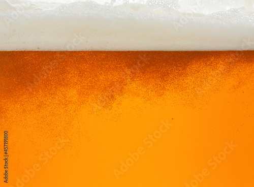 Close up background of beer with bubbles in glass