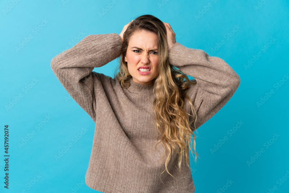 Young Brazilian woman isolated on blue background doing nervous gesture Young Brazilian woman isolated on blue background doing nervous gesture