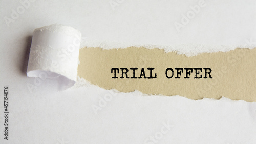 trial offer. words. text on gray paper on torn paper background
