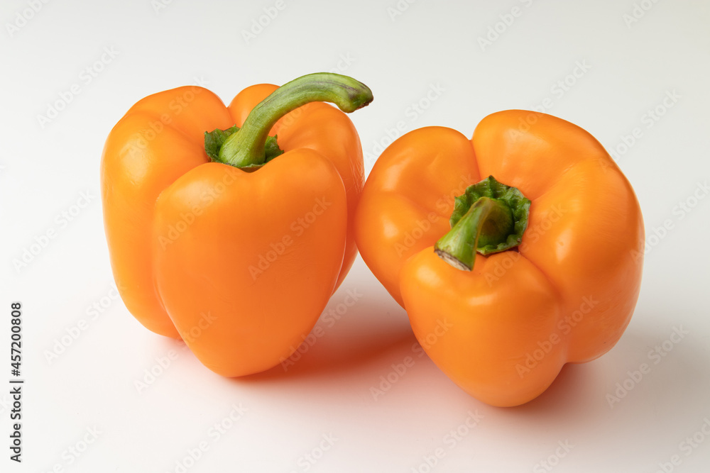 Two orange bell peppers isolated on white background Two orange bell peppers isolated on white background