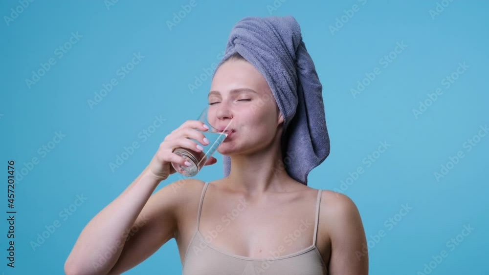 Young woman drinks a cup of cold water and pure Young woman drinks a cup of cold water and pure