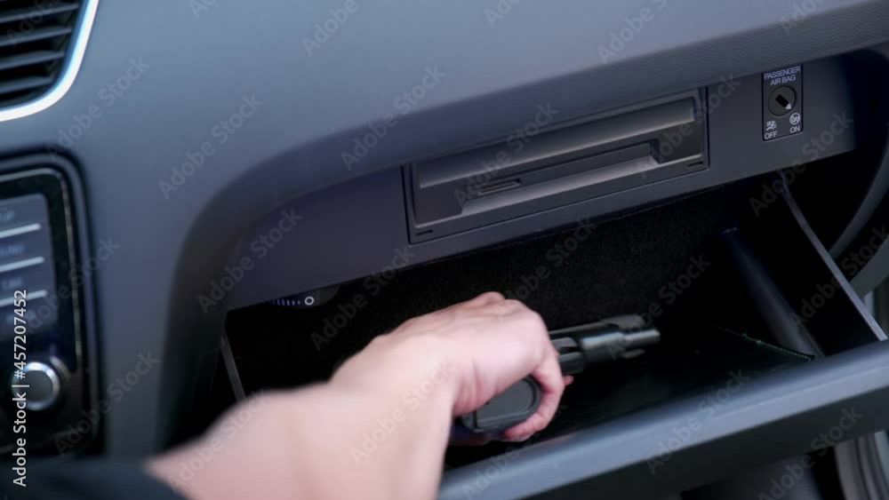 Caucasian Male Pulling Out Concealed Handgun from Car Glove Box Compartment while Pulled Over by Police Patrol with Flashing Blue and Red Lights Caucasian Male Pulling Out Concealed Handgun from Car Glove Box Compartment while Pulled Over by Police Patrol with Flashing Blue and Red Lights