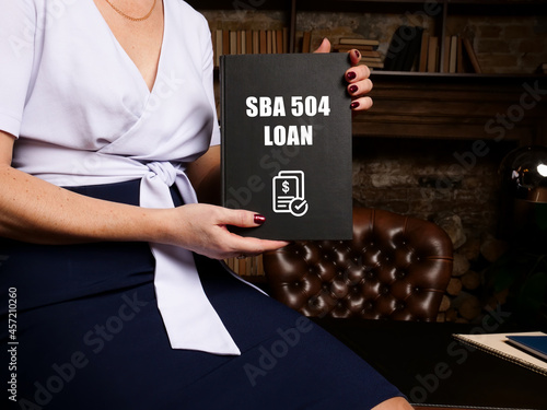 Business concept meaning SBA 504 LOAN with phrase on black notepad. photo