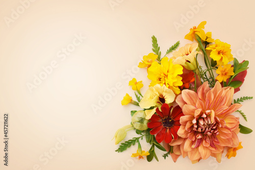Delicate blossoming dahlias and orange flowers, blooming festive fall frame background, autumn bouquet floral card, selective focus, toned	