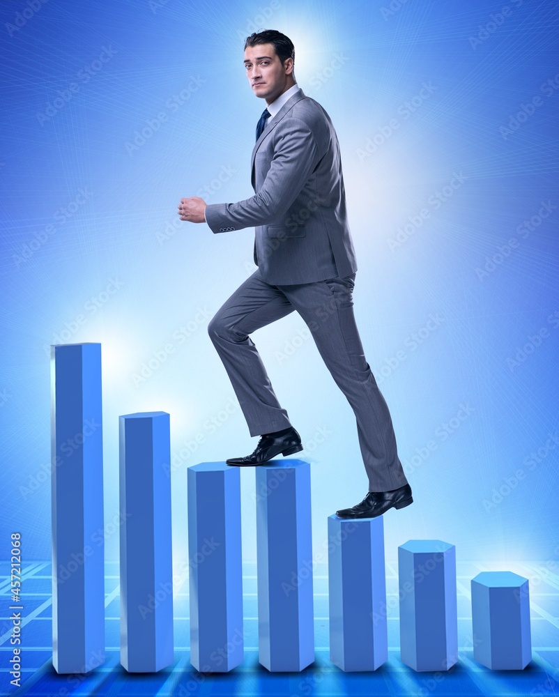Businessman climbing bar charts in business concept