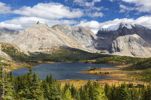 Scenic Landscape View of Beautiful Baker Lake on a Fall Hike in Skoki Area of Banff National Park with Rugged Canadian Rocky Mountain Peaks on Skyline © Autumn Sky