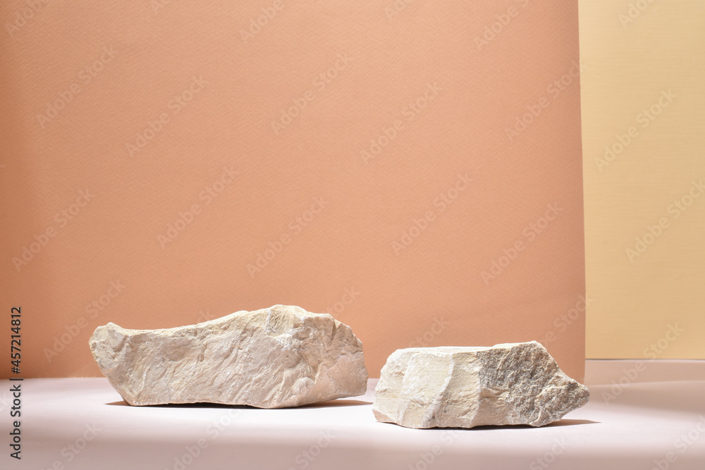 Stone podium for the presentation of goods and cosmetics on a beige background. - obrazy, fototapety, plakaty 
