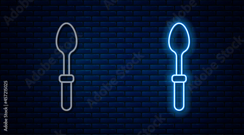Glowing neon line Teaspoon icon isolated on brick wall background. Cooking utensil. Cutlery sign. Vector