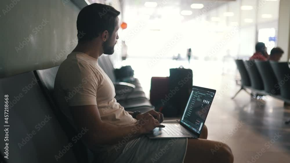 a man working on a laptop in the waiting room a man working on a laptop in the waiting room