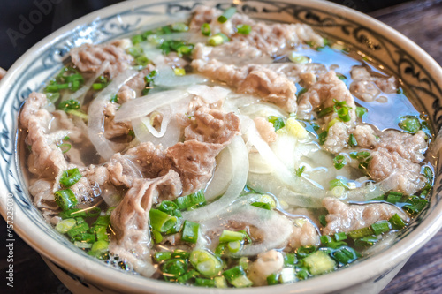 Vietnamese style rice noodles with a lot of beef. photo
