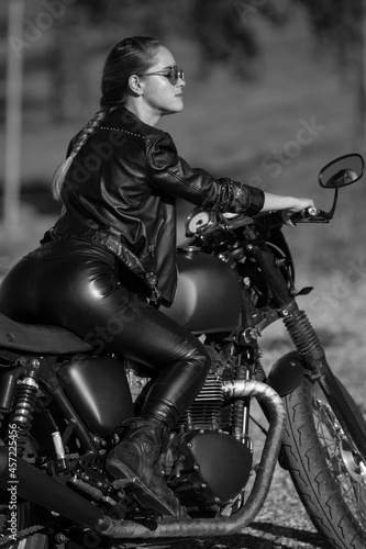 young woman on a black motorcycle © zhagunov_a