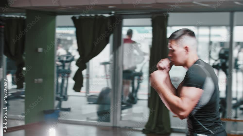 Young man performing shadow boxing in the gym Young man performing shadow boxing in the gym