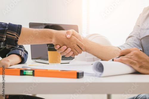 Close up hand of group  team young man contractor  engineer handshake with partnership  customer after agreement to work together at the site  workplace. Business success concept.