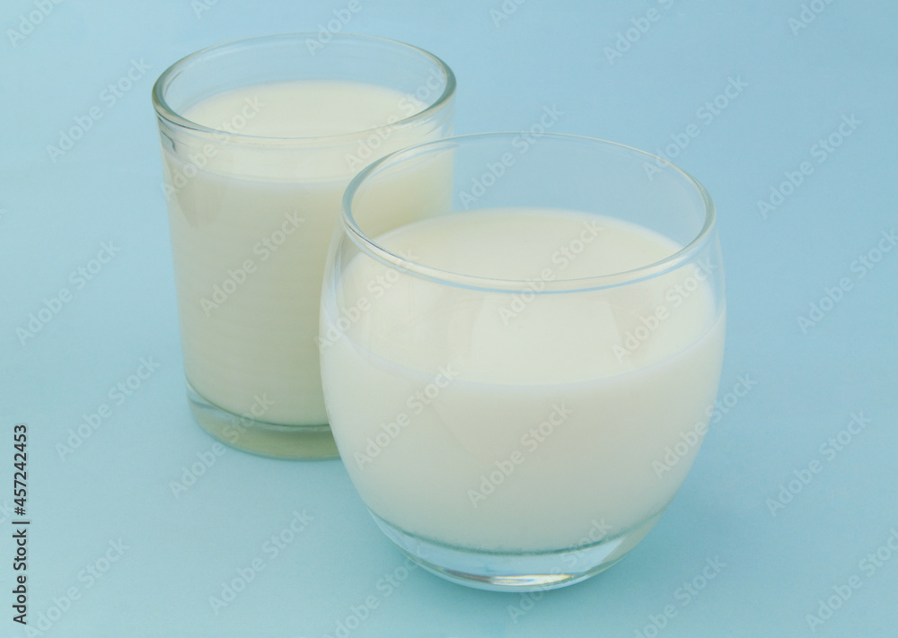 Glasses of milk or cream on blue background Glasses of milk or cream on blue background